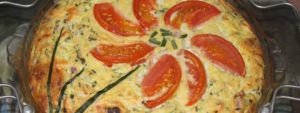 quiche with tomato flower garnish