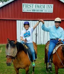 happy riders holding hands at First Farm Inn Kentucky