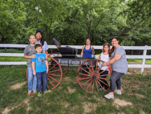 Family poses with antique carriage