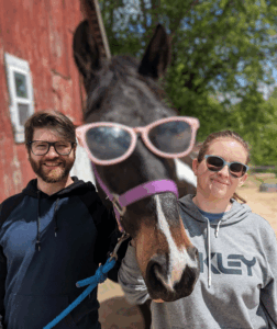 couple with horse in sunglasses